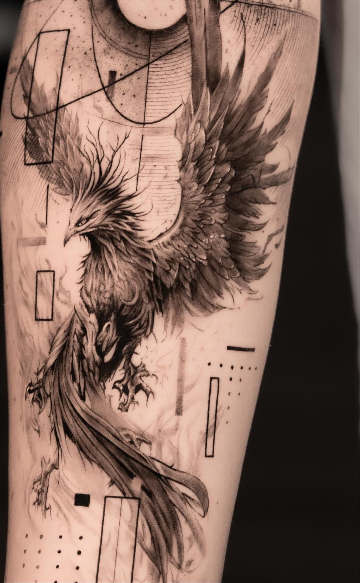 Phoenix tattoo with geometric lines and shapes on a person's skin.