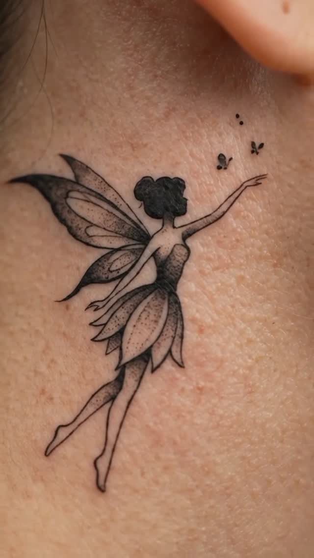 Fairy tattoo on shoulder with large wings and small floating butterflies.