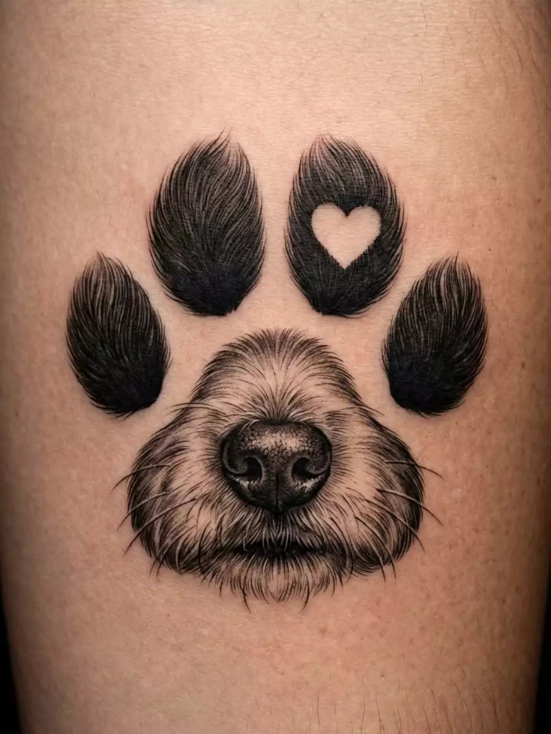 Dog paw tattoo featuring a realistic nose and muzzle with a heart detail.