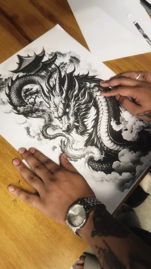 Detailed black ink drawing of a winding dragon surrounded by clouds on paper.