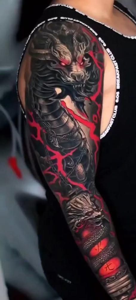 Robotic dragon sleeve tattoo with black ink and glowing red mechanical details.