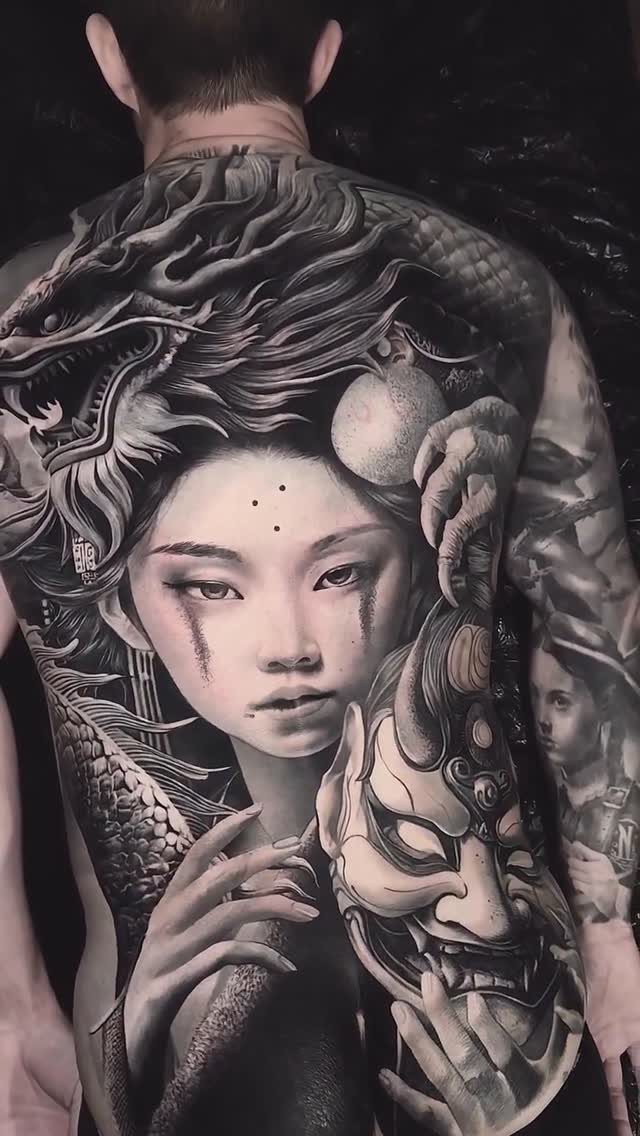 Full back tattoo featuring a woman, a Japanese mask, and a detailed dragon.
