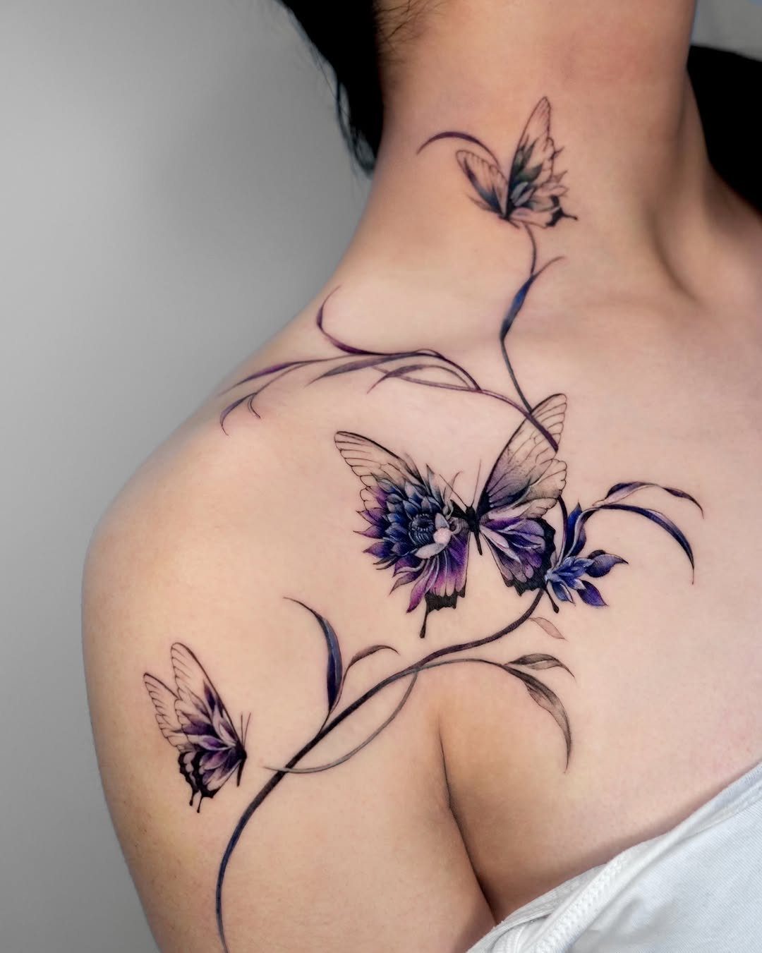 Purple flower and butterfly tattoo flowing from the shoulder up to the neck.