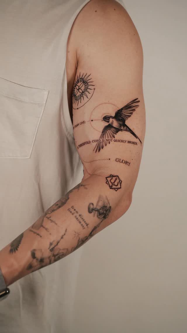 Hummingbird tattoo with geometric circles and text on a man's upper arm.