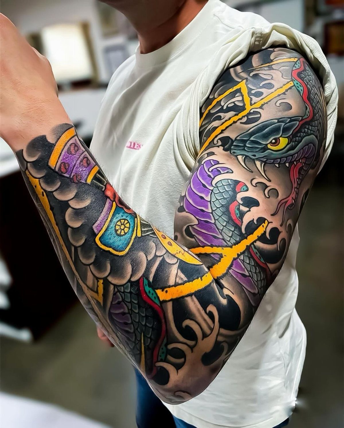 Japanese snake tattoo sleeve with purple scales and dark swirling cloud backgrounds