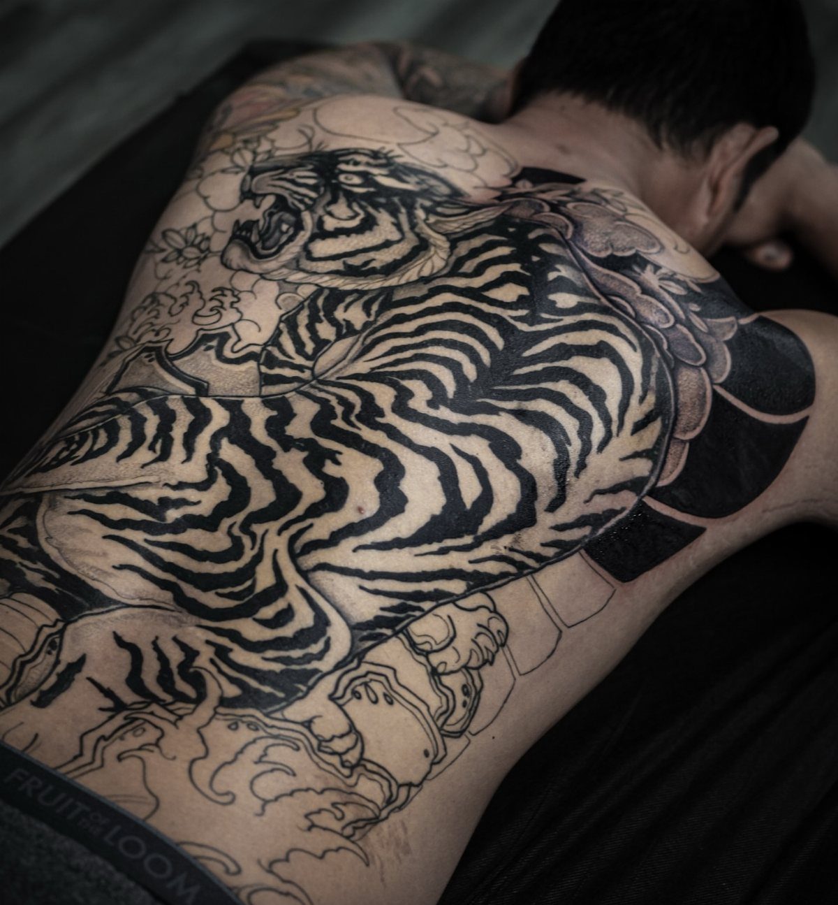 Large Japanese tiger tattoo covering the entire back of a person.