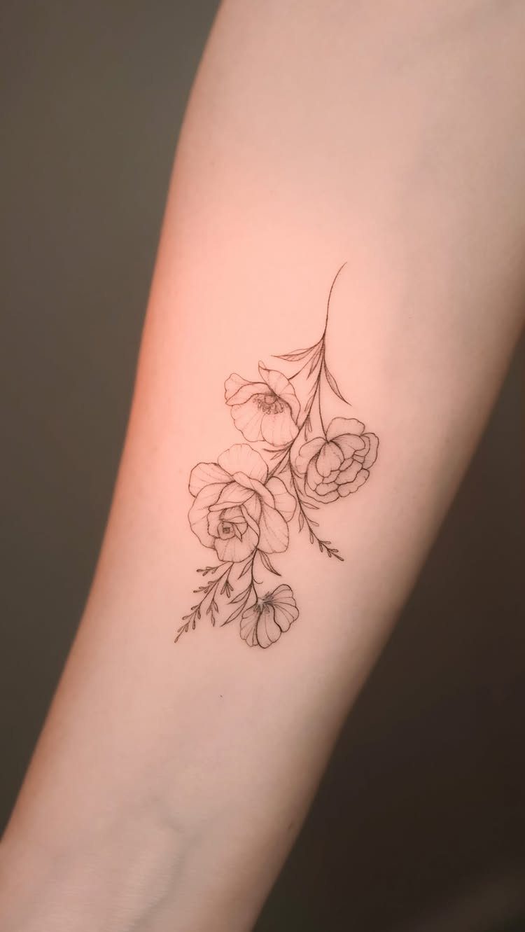 Fine line rose tattoo on a person's forearm with delicate black ink details.