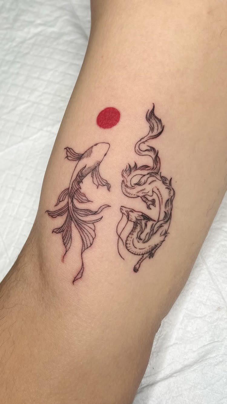 Two koi fish tattoo on a forearm with a small red sun above.