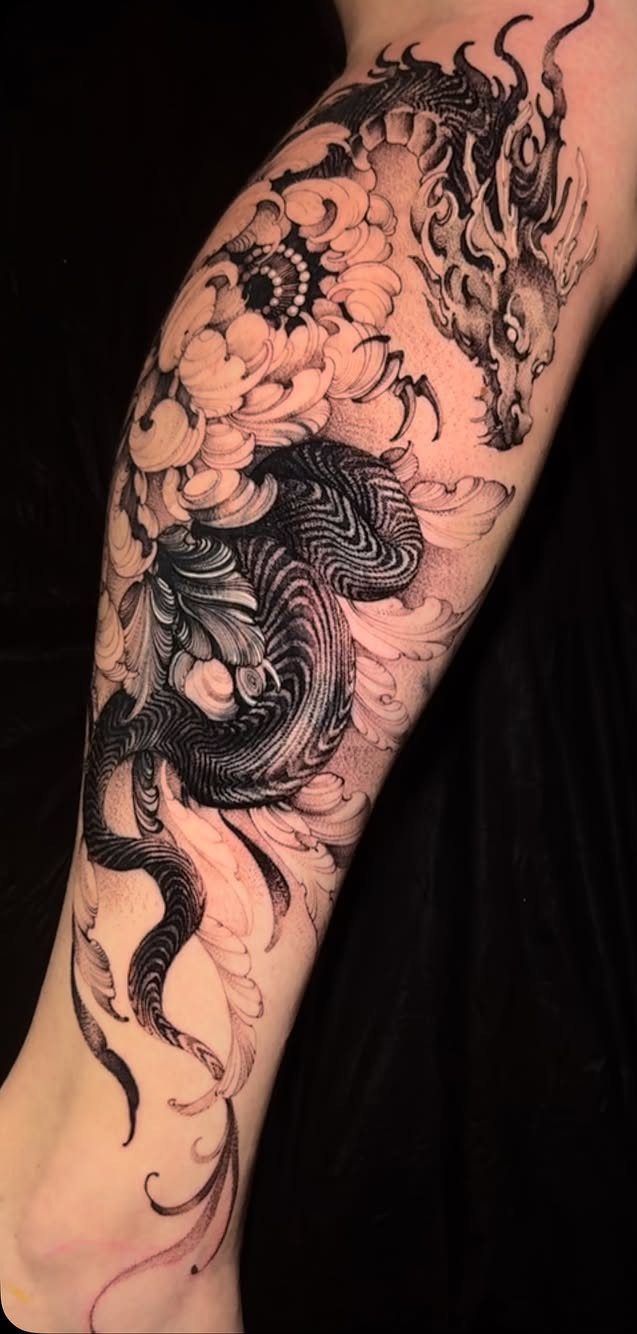 Black and gray tattoo of a Japanese dragon and peony flowers on a leg