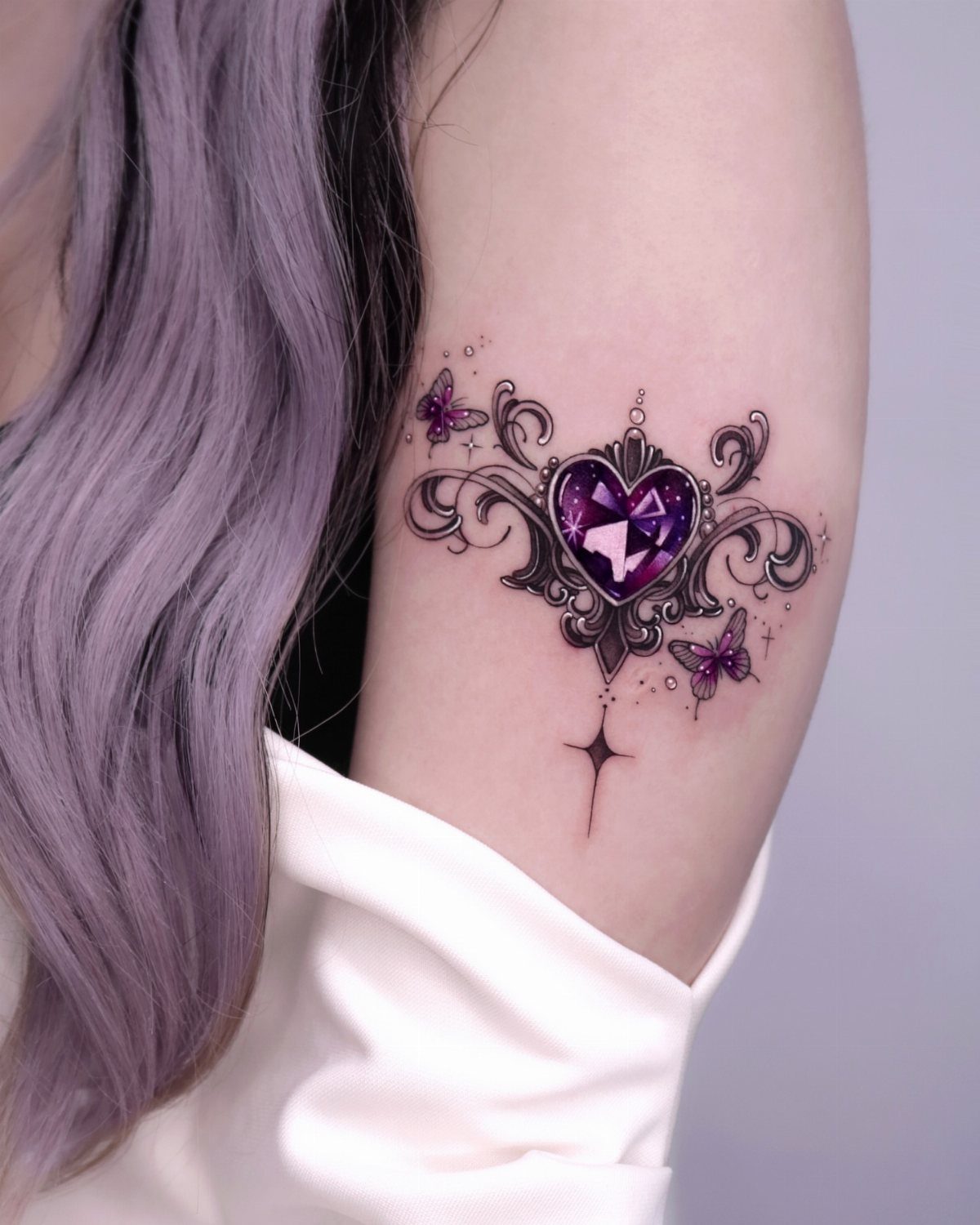 Purple heart gemstone tattoo with small purple butterflies and ornate black swirls.