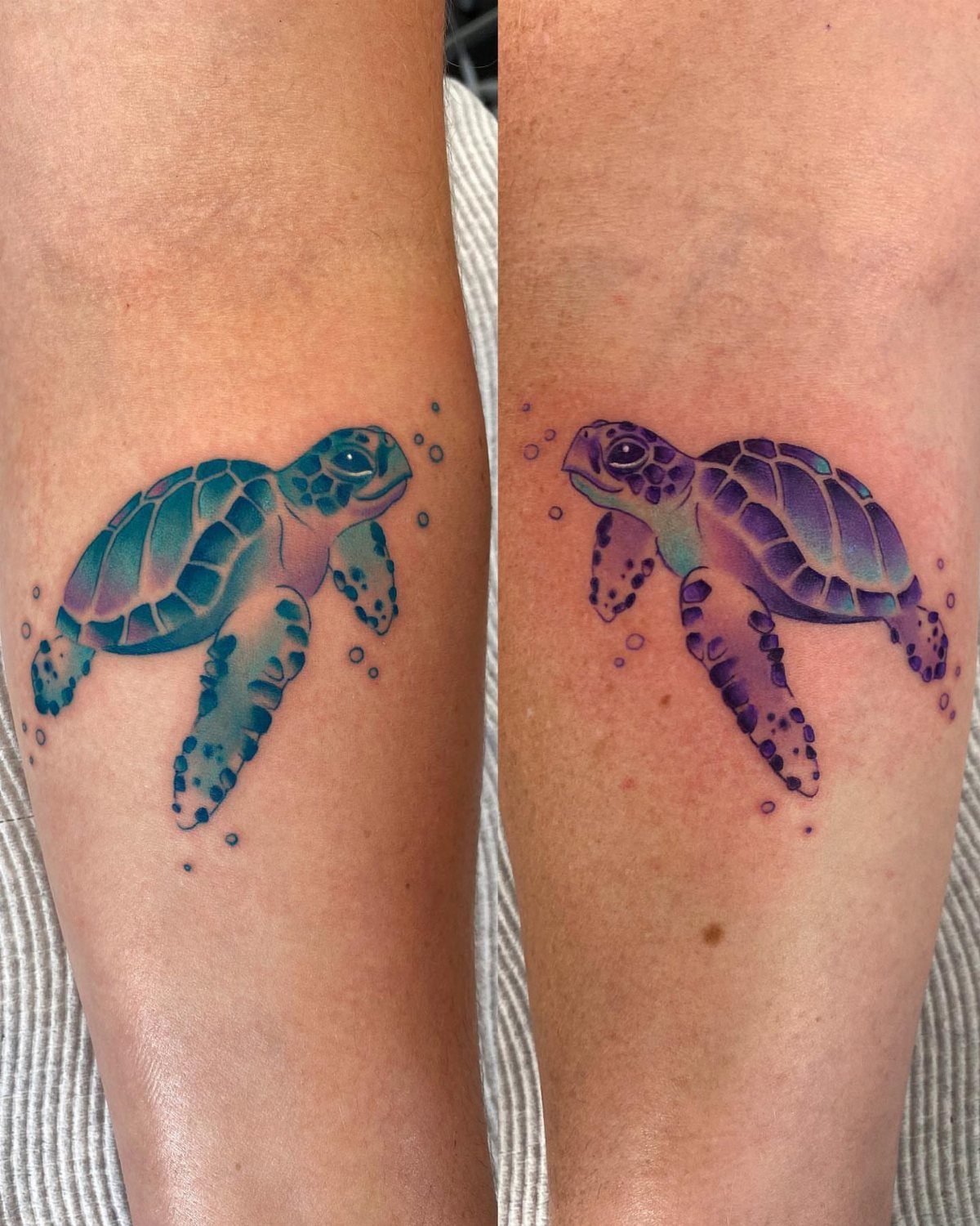 Two matching watercolor sea turtle tattoos on legs in blue and purple tones.