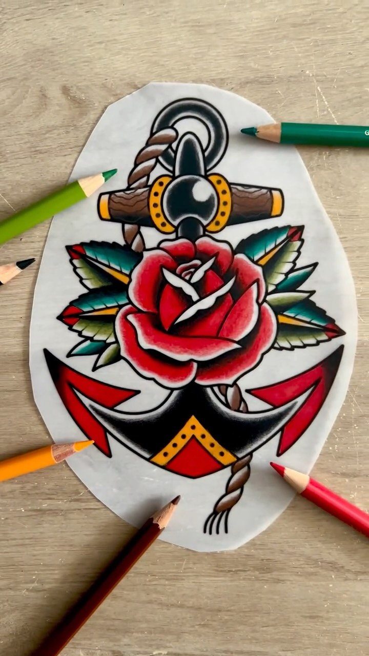 Traditional tattoo design of a red rose and black anchor on white paper.