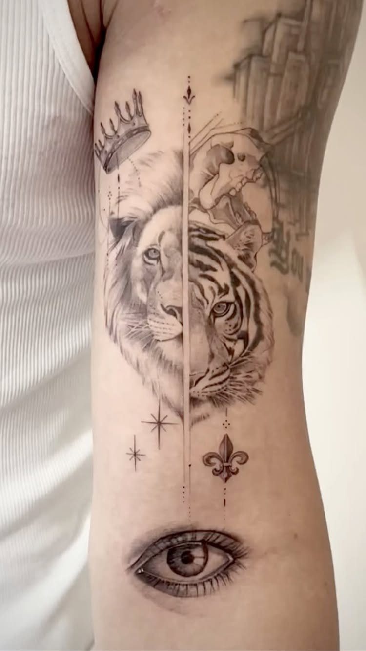 Split face tattoo of a lion and tiger on a person's arm.
